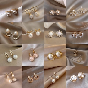 Collection of 16 pairs of s925 silver pearl earrings with gold accents and zircon details
