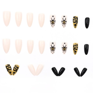 Long stiletto press-on nails featuring yellow and black snake and mystic moon patterns