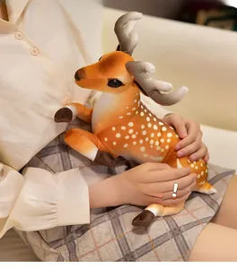 Detail showing a person holding a plush deer toy with realistic white spots and soft antlers