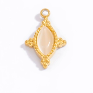 Macro detail of a vintage 18k gold cross pendant featuring a marquise white moonstone