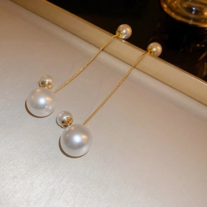 Gold-plated pearl earrings with elegant long tassel drop design and glossy finish