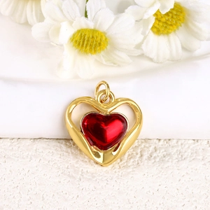 Detailed macro of 18k gold plated hollow heart pendant with red oil drip effect