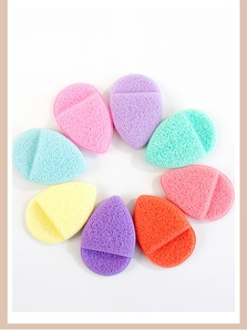 Detailed view of eight colorful drop-shaped makeup sponges in a circular arrangement