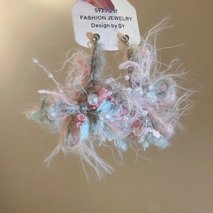 Detail shot of pink and blue crochet flower earrings with pearls and S925 silver needles