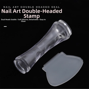 Close-up of double-headed nail art stamper with clear silicone tips and scraper