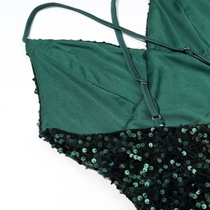 Detailed view of dark green sequin dress back with crossed thin shoulder straps