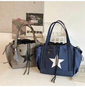 Macro detail of waterproof nylon bags with large stars and checkerboard charm