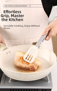 Silicone and stainless steel food tongs with stand used for cooking pork in a frying pan