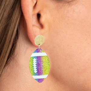 Detailed view of rainbow glitter rugby earring with a golden stud on ear