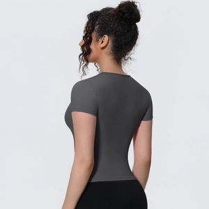 Close-up of moisture-wicking charcoal grey yoga shirt fabric and athletic slim fit seams