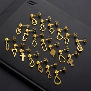 Set of gold stainless steel stud earrings with geometric shapes and symbols on black background