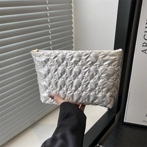 Quilted heart pattern white cosmetic bag with elegant gold zipper for makeup storage