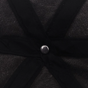 Macro detail of the inner crown stitching and silver metal rivet of the black cotton beanie