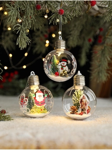 Close-up of clear Christmas ornament with Santa figurine and Merry Christmas text