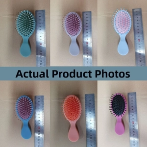 Detailed size comparison of mini portable air cushion combs in six colors with a ruler