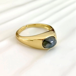 Retro gold adjustable ring with oval grey natural labradorite stone on white surface