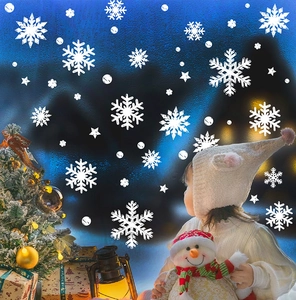 Detailed white snowflake window clings with various sizes and star patterns on glass
