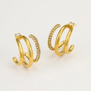 Detailed macro view of 18K gold-plated triple-hoop earrings with micro-pave cubic zirconia