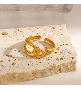 Detailed view of gold plated stainless steel twisted ring on a travertine stone base