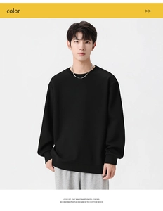 Close-up of black loose fit jacquard sweatshirt featuring textured fabric and crew neck
