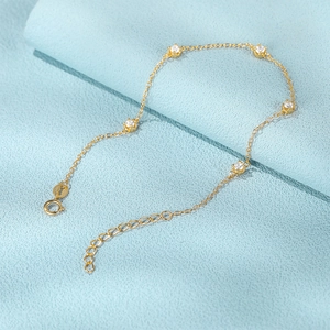 Detailed close-up of S925 sterling silver gold bracelet with sparkling clear gemstones