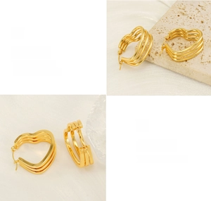 Detailed view of polished gold triple-layer heart hoop earrings on minimalist stone
