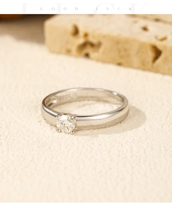 Macro detail of S925 sterling silver stamp and sparkling round moissanite four-prong setting