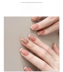 French pale yellow press-on nails with cream tips and silver glitter bow accents