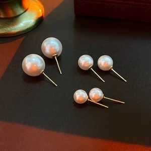 Three pairs of white pearl stud earrings in small, medium, and large sizes with gold posts