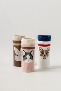 Close-up of knit five-toe yoga socks with cartoon rabbit, cat, and dog patterns
