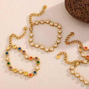 Detailed shot of 18K gold plated stainless steel bracelets with zircon stones on stone