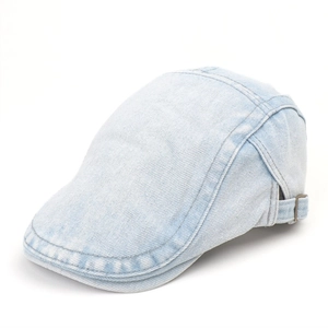 Close-up of light blue denim flat cap showing washed texture and side metal buckle detail