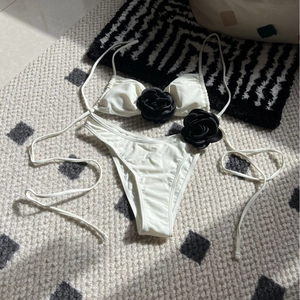 Black and white bikini set with 3D rose flower detail and adjustable string ties