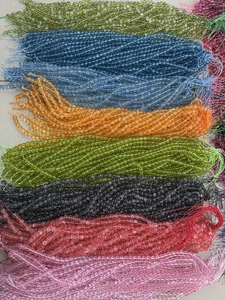 Macro detail of various colorful translucent round beads for DIY jewelry making and crafts