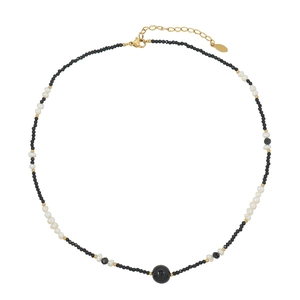 French vintage necklace with black spinel beads and natural pearls on white background