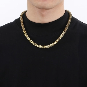 Men's 8mm 18K gold-plated titanium Byzantine chain worn by a model on a black background