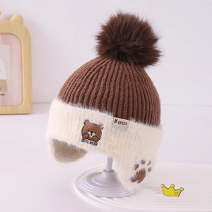 Detail of cute bear embroidery and thick knit texture on kids' warm winter earflap hat