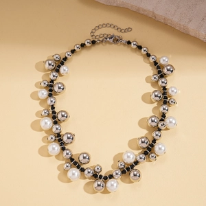 Detail of beaded necklace with silver metal beads, faux pearls and lobster clasp closure