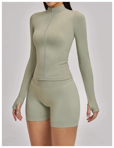 Detail of grey-green yoga jacket featuring windproof thumb holes and seamless ribbed cuffs