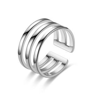 Detailed macro of silver polished triple-layer geometric open ring on white backdrop