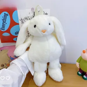 Detail of white plush bunny backpack featuring cute floppy ears and soft faux fur texture