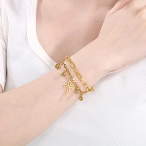 Double-layered gold stainless steel chain bracelet with cross and ball charms on model