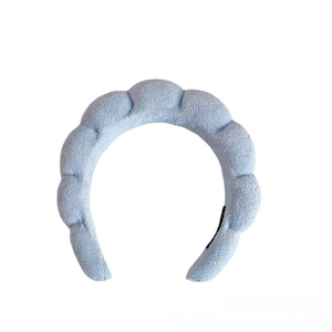 Macro view of light blue padded cloud headband with absorbent plush terry cloth texture