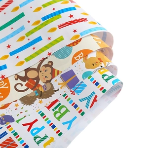 Rolls of colorful cartoon birthday wrapping paper with Happy Birthday letter prints