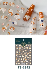 Detail of 5D embossed cat nail art stickers featuring cute orange cats and paw prints