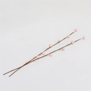 Macro shot of artificial light pink berries on brown branches for DIY spring decor
