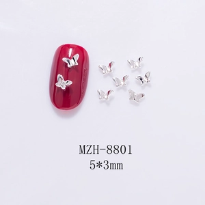 Close-up of 5x3mm silver hollow butterfly nail art charms with dimensions and scale detail