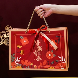 Elegant red Chinese wedding gift bag with gold handles and Wu Jia You Xi lettering