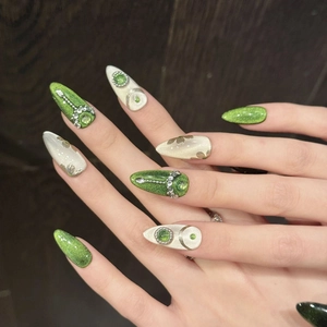 Handmade emerald cat eye press-on nails with 3D floral accents and pearl details
