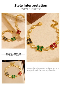 Detail of gold-plated butterfly bracelet featuring colorful inlaid gems and lobster clasp